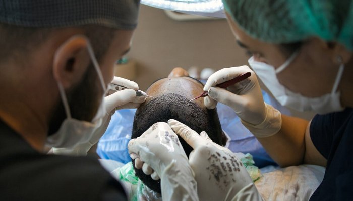 Doctors doing patient hair transplant